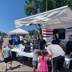 Pictured is the Northland trailer and employees serving snocones at AuSable Canoe Marathon