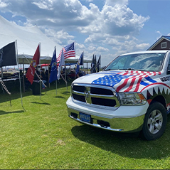 Pictured is a Northland truck and flags of each branch of the military on Lake Huron